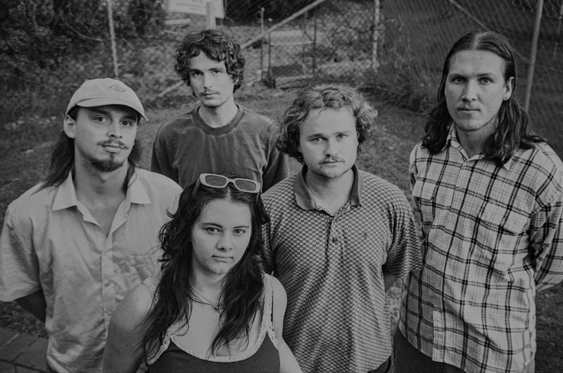 The five members of Aodhan standing close together outdoors, black and white