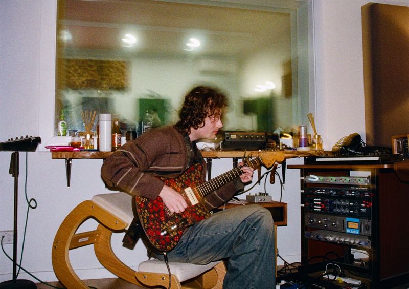 Aodhan in the studio: playing a paisley guitar in the control room