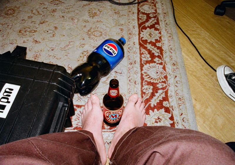 Aodhan in the studio: feet up on the studio rug beside a flight case