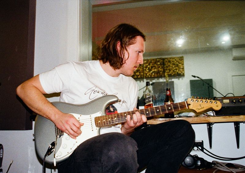 Aodhan in the studio: guitarist playing a silver electric guitar
