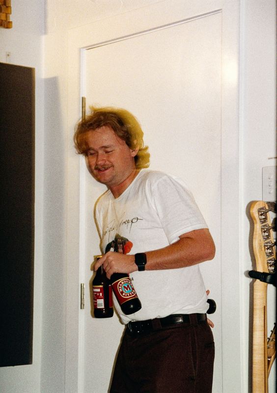 Aodhan in the studio: coming through the studio door carrying bottles